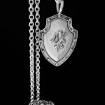 Shield pendant with lion on silver chain.