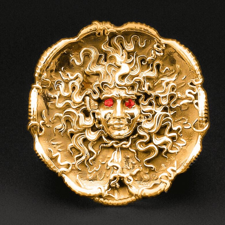 Golden Medusa head with red eyes.