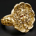 Gold Medusa ring with intricate detailing.