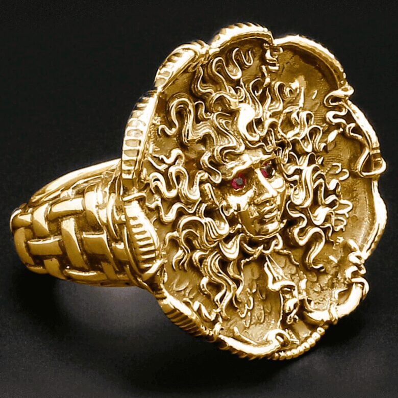 Gold Medusa ring with intricate detailing.