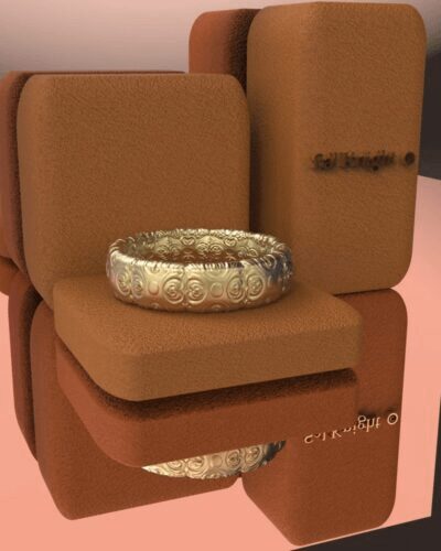 A gold ring sitting on top of a brown box.