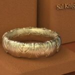 A gold ring sitting on top of a box.
