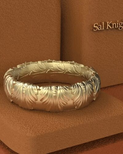 A gold ring sitting on top of a box.