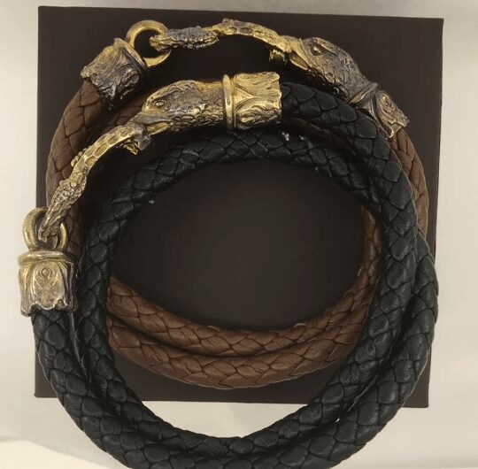 Braided leather bracelets with ornate metal clasps.