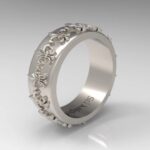 A silver ring with flowers on it