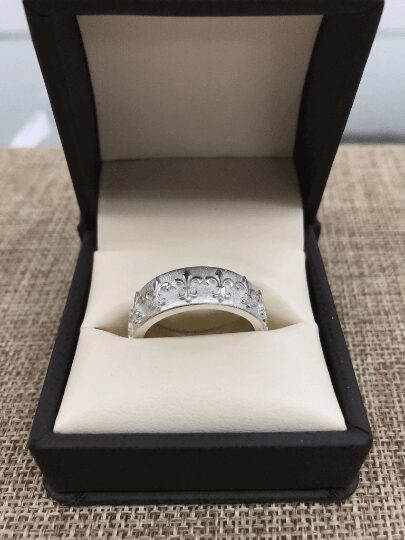 Silver ring in black jewelry box.