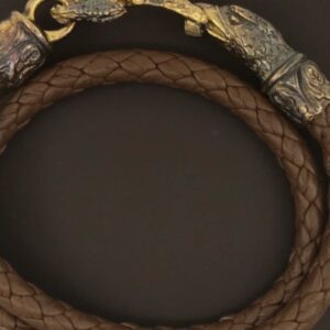 A brown leather bracelet with gold plated clasp.