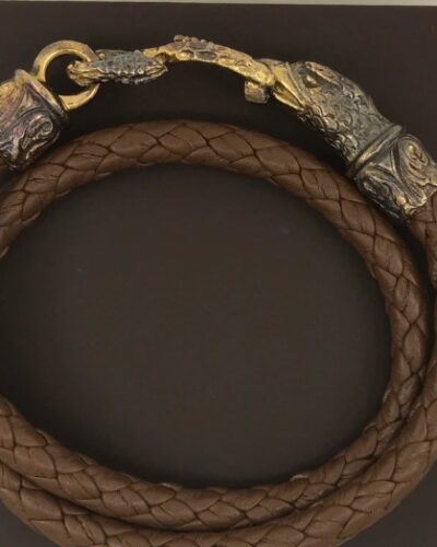 A brown leather bracelet with gold plated clasp.