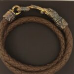 Brown braided leather bracelet with ornate clasp.
