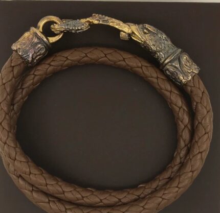 Brown braided leather bracelet with ornate clasp.