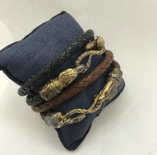 Braided leather bracelets with gold accents.