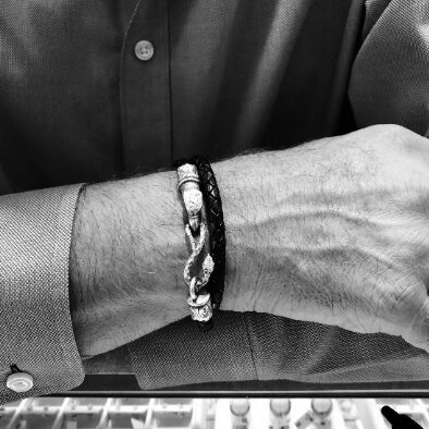 Man wearing a braided bracelet, black and white.