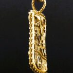A gold pendant with the word " new york ".